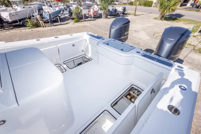 Slide: The Image of 2014 Freeman 33 boat deck with open storage compartments and dual Yamaha outboard engines. - 32