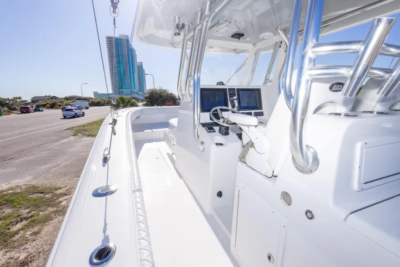 Slide: The Image of 2014 Freeman 33 boat interior with modern controls, docked near a road and buildings. - 36