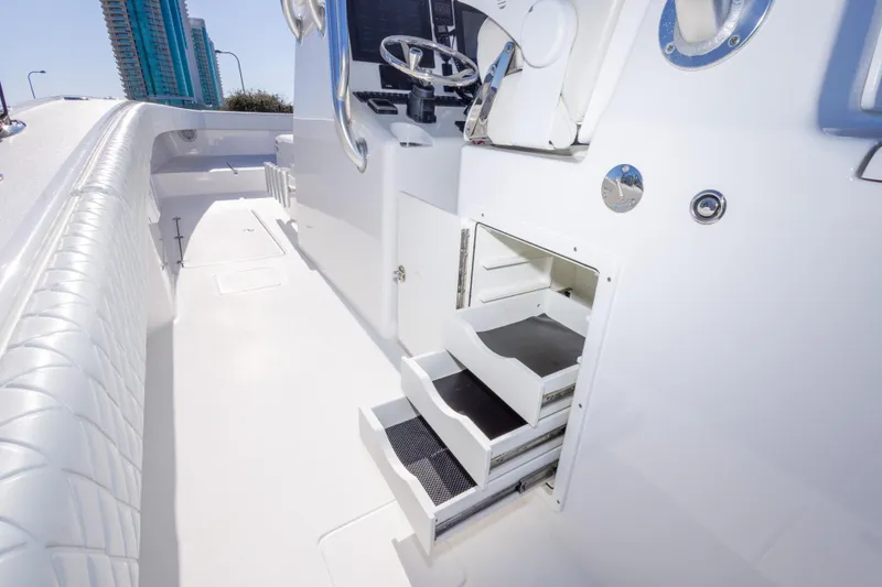 Slide: The Image of Interior view of a 2014 Freeman 33 boat, featuring sleek white design and storage compartments. - 37