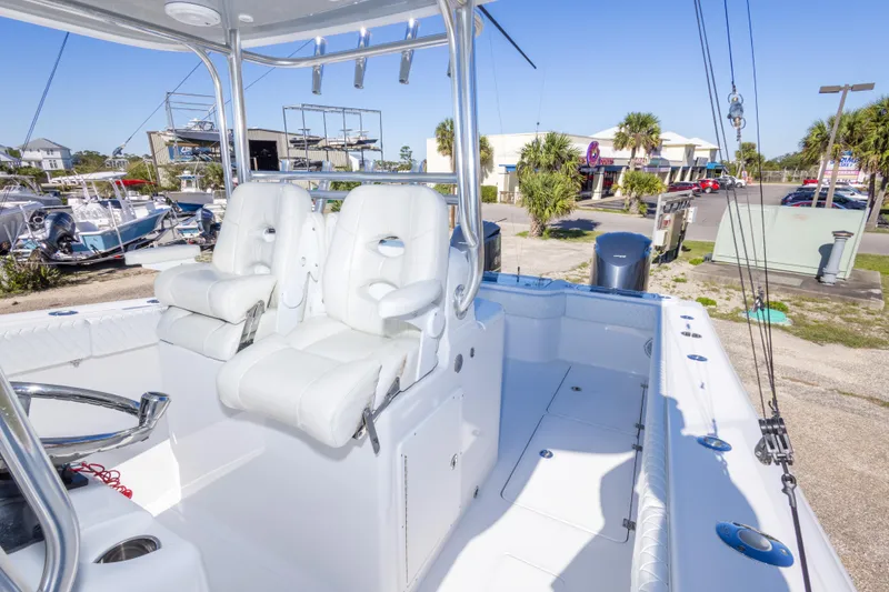 Slide: The Image of 2014 Freeman 33 boat interior with white seating and fishing rod holders. - 40