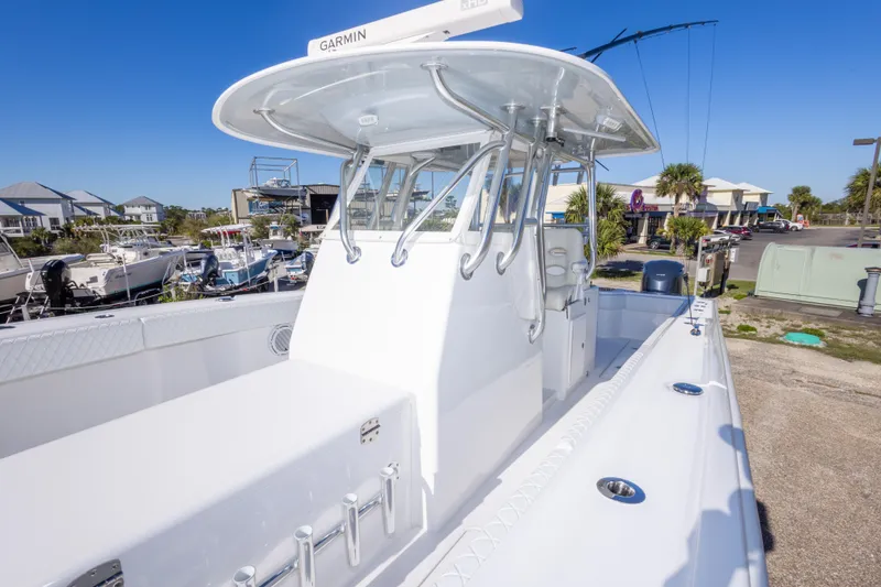 Slide: The Image of 2014 Freeman 33 boat with Garmin equipment, docked in a marina under clear blue skies. - 47