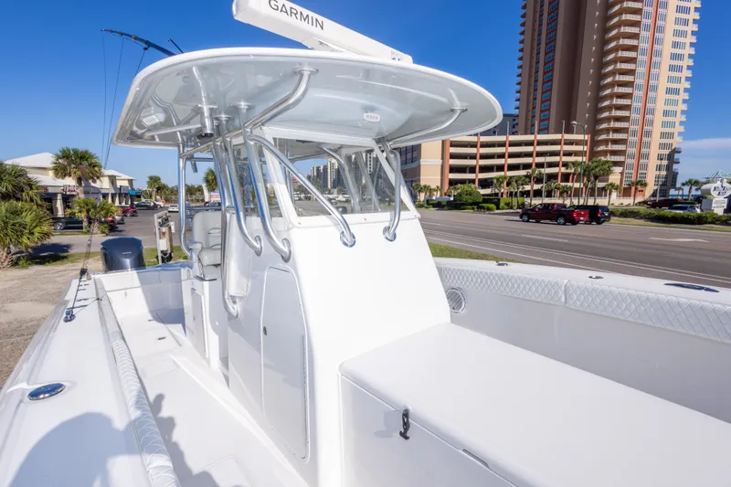 Slide: The Image of 2014 Freeman 33 boat with Garmin equipment, docked near a coastal cityscape. - 48