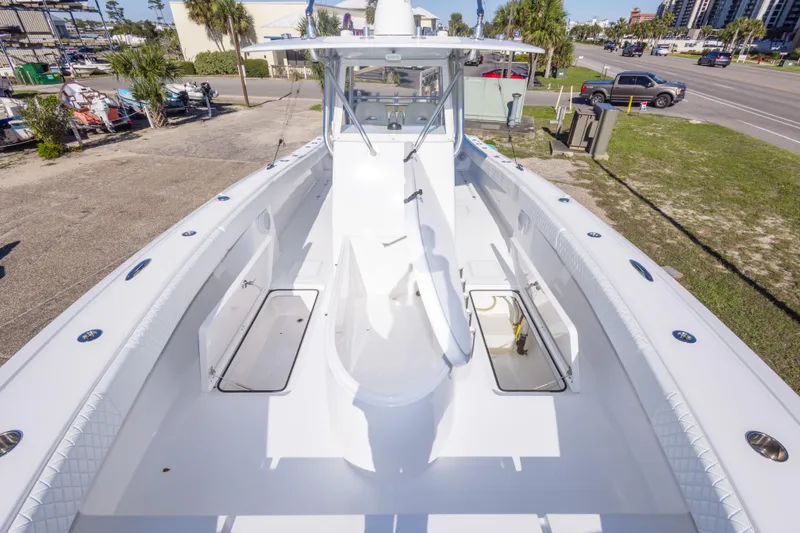 Slide: The Image of 2014 Freeman 33 boat deck with open storage compartments, parked near a road. - 53