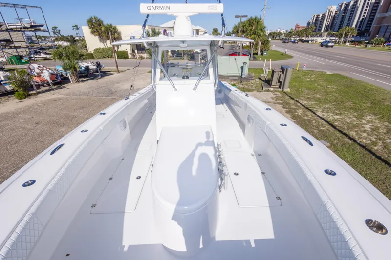 Slide: The Image of 2014 Freeman 33 boat with Garmin equipment, docked near a road and buildings. - 56