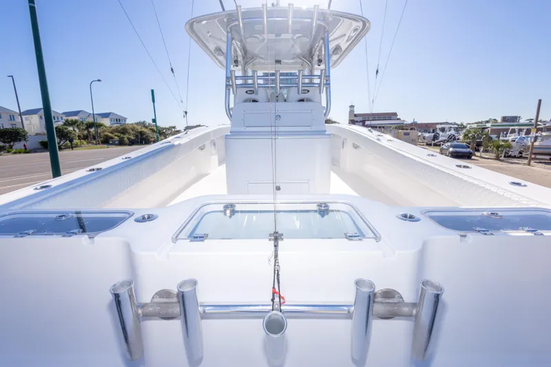 Slide: The Image of Freeman 33 boat, 2014 model, featuring sleek white deck and fishing rod holders. - 57