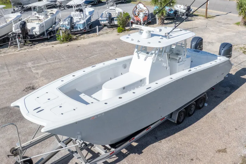 Slide: The Image of Freeman 33 boat, 2014 model, on trailer in a marina with other boats. - 9