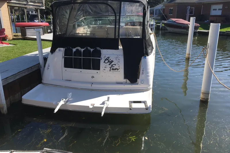 Slide: The Image of 2004 Rinker Fiesta Vee 312 boat docked in a calm marina setting. - 11