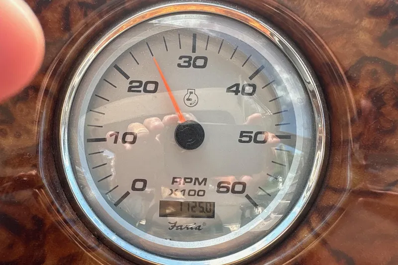 Slide: The Image of Tachometer of 2004 Rinker Fiesta Vee 312 boat showing RPM and engine hours. - 14
