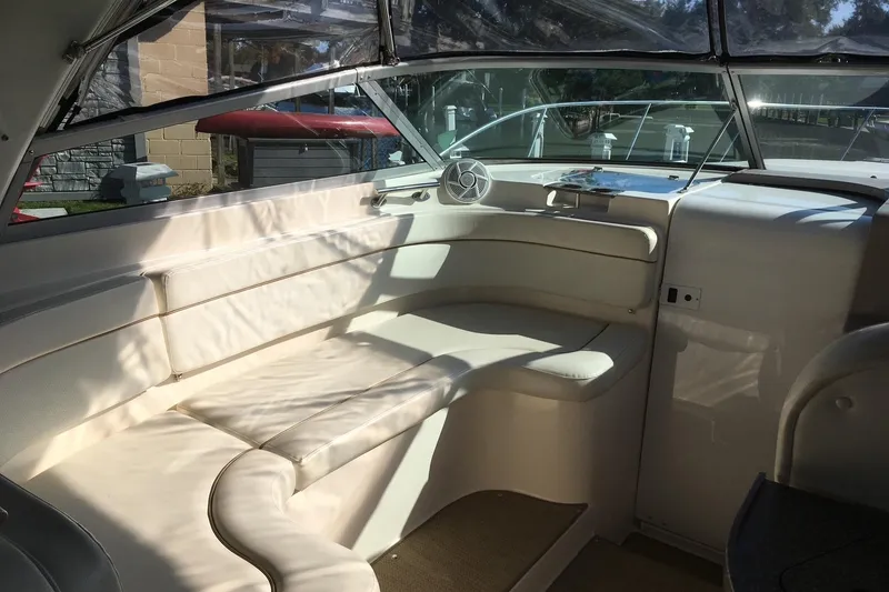 Slide: The Image of Interior of a 2004 Rinker Fiesta Vee 312 boat with white seating and windows. - 9