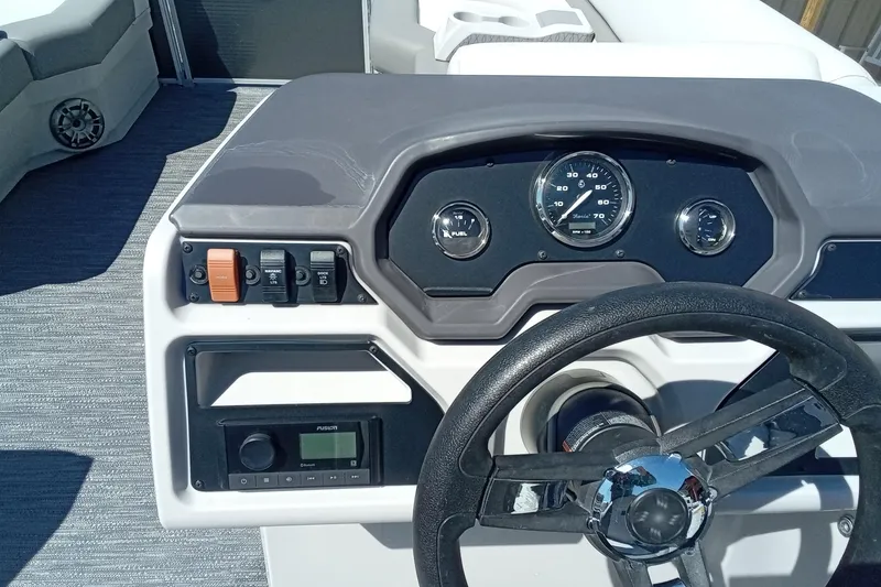 Slide: The Image of 2023 Godfrey Sweetwater 2086 CX boat dashboard with steering wheel and gauges. - 11