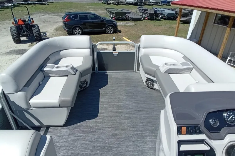 Slide: The Image of 2023 Godfrey Sweetwater 2086 CX pontoon boat interior with plush seating and modern dashboard. - 12