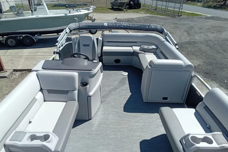 Slide: The Image of 2023 Godfrey Sweetwater 2086 CX pontoon boat interior with spacious seating and helm. - 13