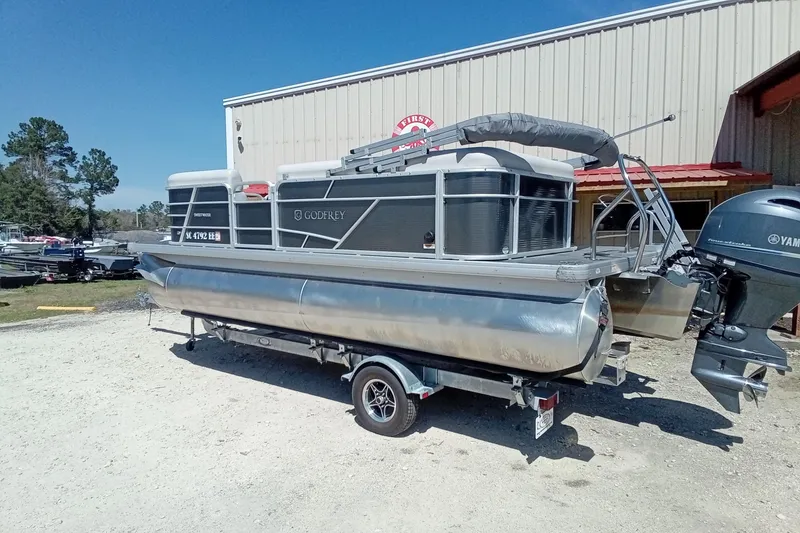 Slide: The Image of 2023 Godfrey Sweetwater 2086 CX pontoon boat on trailer, parked outdoors. - 14