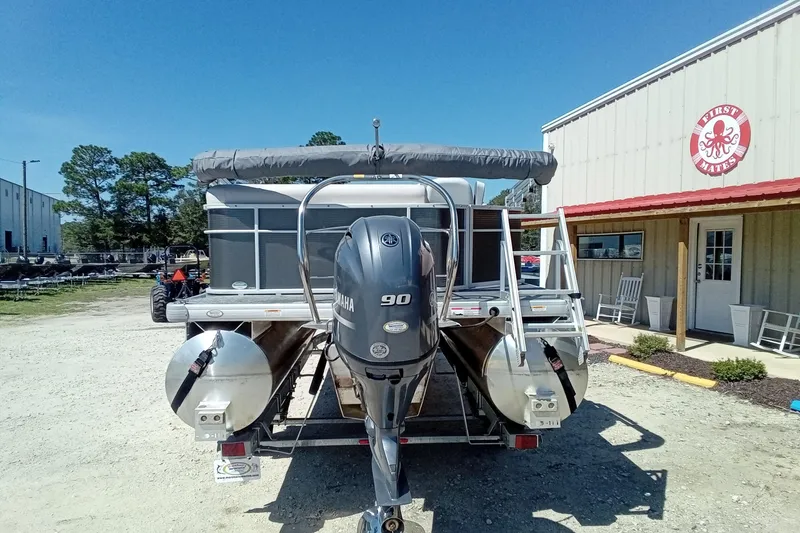 Slide: The Image of 2023 Godfrey Sweetwater 2086 CX pontoon boat with Yamaha 90 engine, parked outside a building. - 15