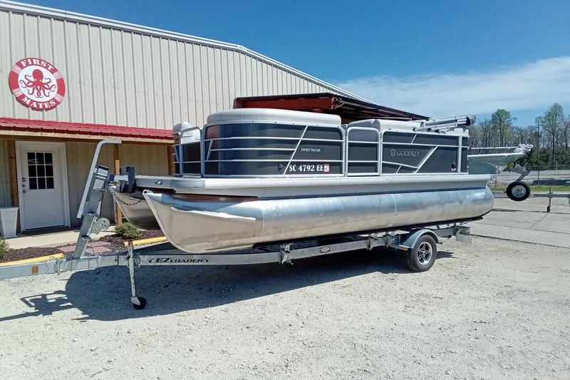 Slide: The Image of 2023 Godfrey Sweetwater 2086 CX pontoon boat on trailer outside First Mates building. - 3