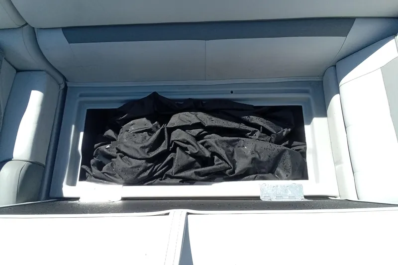 Slide: The Image of Storage compartment in 2023 Godfrey Sweetwater 2086 CX boat with black fabric inside. - 8