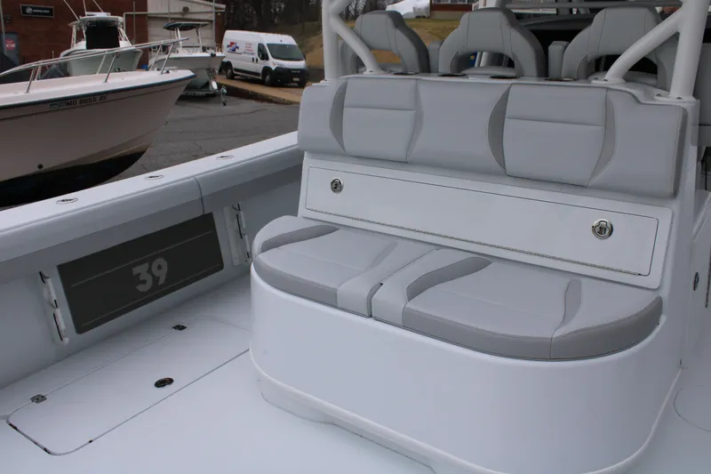 Slide: The Image of 2026 Yellowfin 39 Offshore boat interior with gray seating and storage compartment. - 10