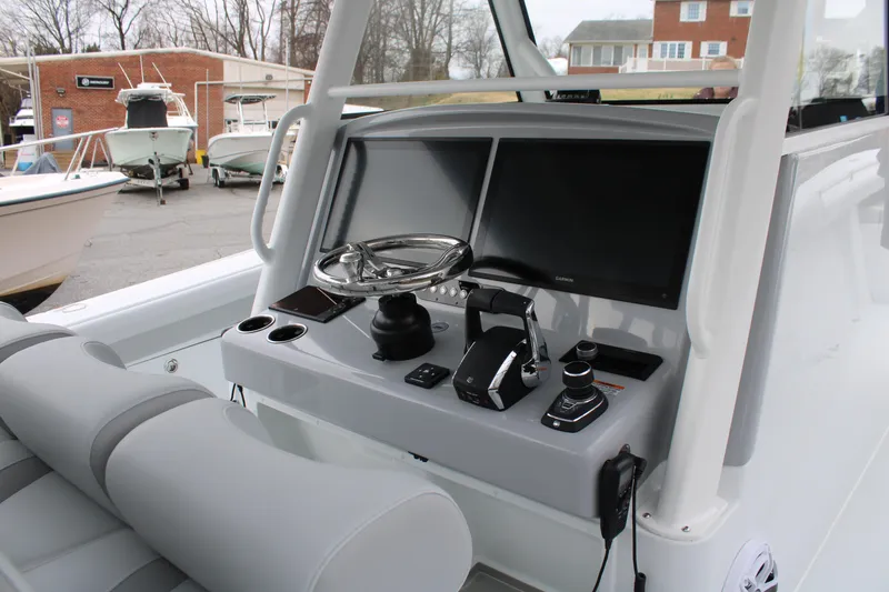Slide: The Image of 2026 Yellowfin 39 Offshore boat dashboard with steering wheel and navigation screens. - 11