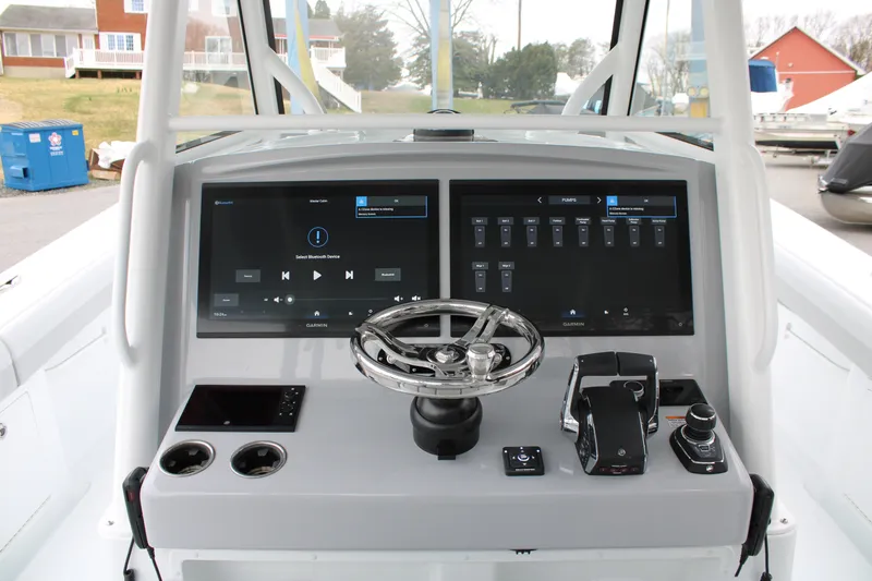 Slide: The Image of 2026 Yellowfin 39 Offshore boat dashboard with dual Garmin displays and modern controls. - 12