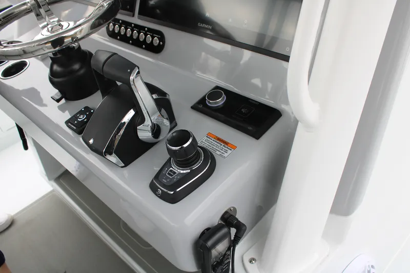 Slide: The Image of 2026 Yellowfin 39 Offshore boat console with steering wheel and control panel. - 13