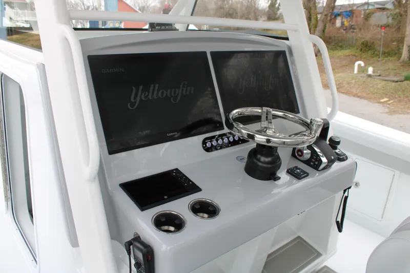 Slide: The Image of 2026 Yellowfin 39 Offshore boat helm with dual Garmin displays and stainless steel steering wheel. - 15