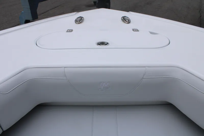 Slide: The Image of 2026 Yellowfin 39 Offshore boat interior with white cushioned seating and storage compartment. - 19