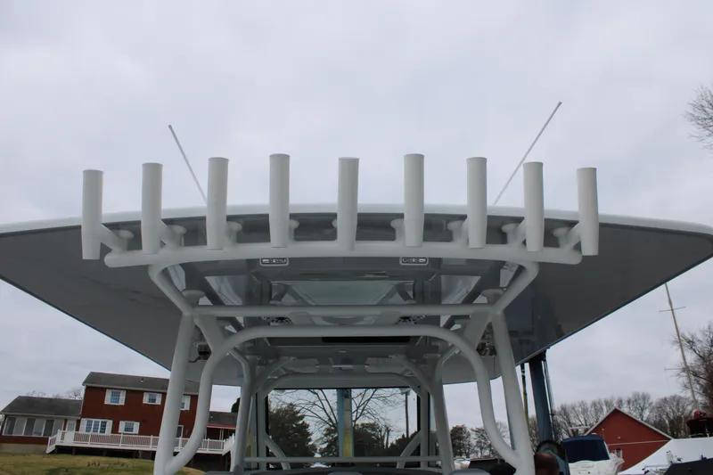 Slide: The Image of 2026 Yellowfin 39 Offshore boat with rod holders and T-top against cloudy sky. - 24