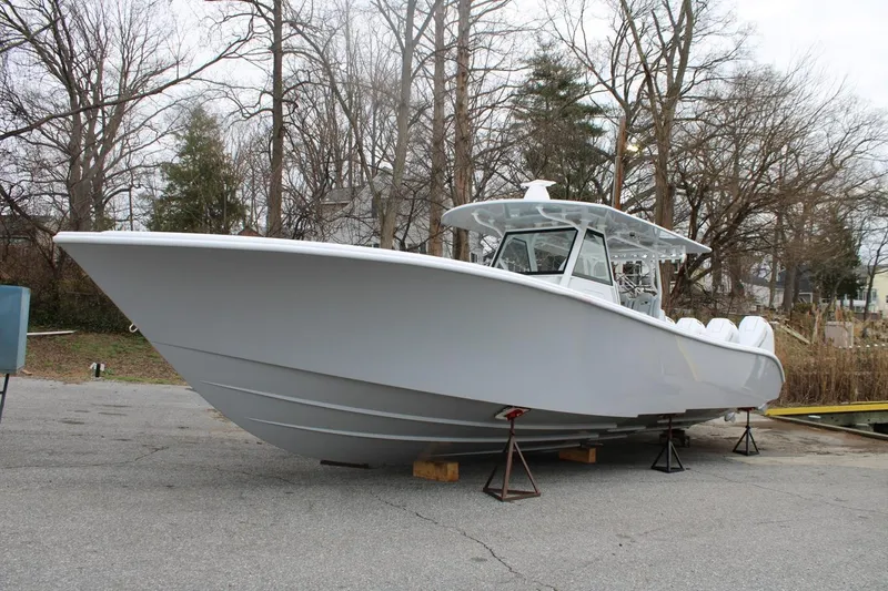 Slide: The Image of 2026 Yellowfin 39 Offshore boat on stands, surrounded by trees. - 3