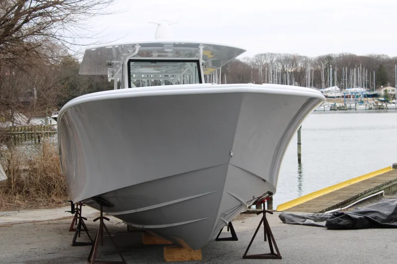 Slide: The Image of 2026 Yellowfin 39 Offshore boat on stands by the water. - 5