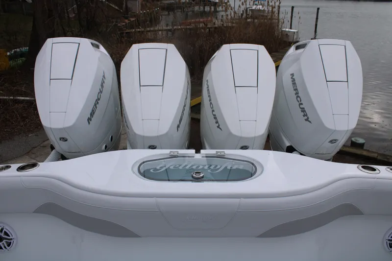 Slide: The Image of 2026 Yellowfin 39 Offshore boat with four Mercury engines docked by the water. - 7