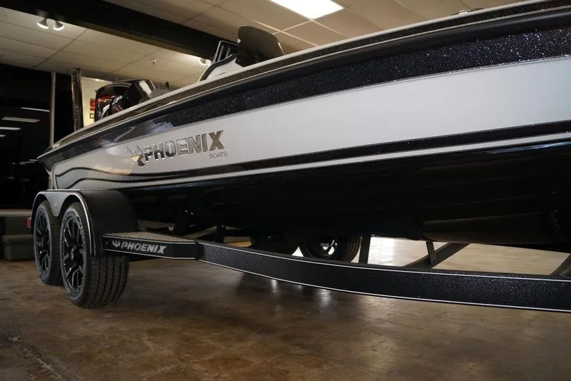 Slide: The Image of 2026 Phoenix 920 Elite X boat on trailer, showcased indoors. - 10