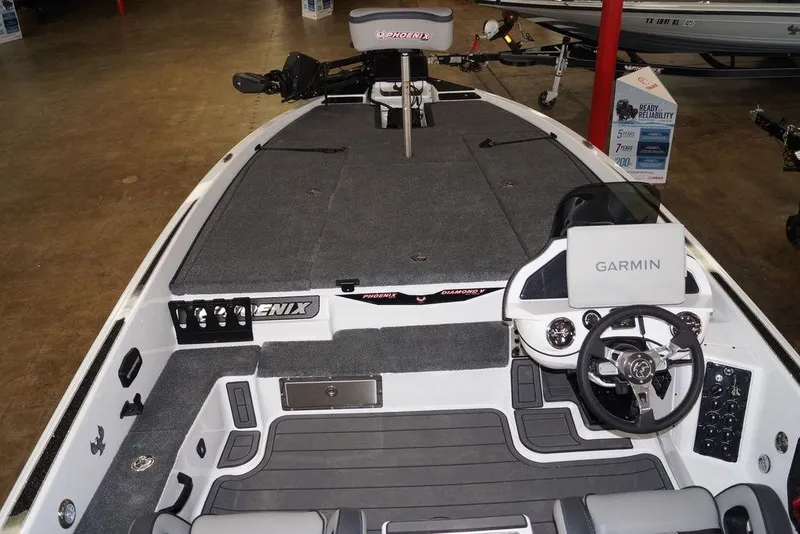 Slide: The Image of 2026 Phoenix 920 Elite X boat interior with Garmin navigation system and spacious deck. - 13