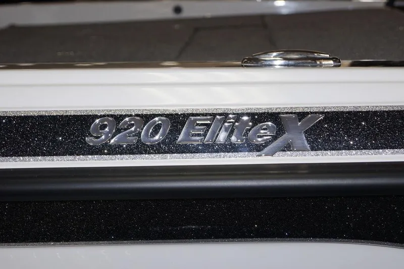 Slide: The Image of Close-up of 2026 Phoenix 920 Elite X logo on a glittery black surface. - 4