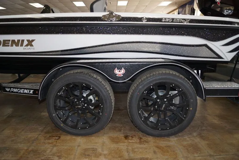 Slide: The Image of 2026 Phoenix 920 Elite X boat trailer with black wheels and sleek design. - 6