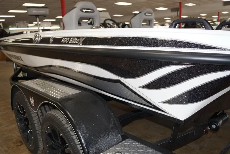 Slide: The Image of 2026 Phoenix 920 Elite X boat with sleek black and white design on trailer. - 9