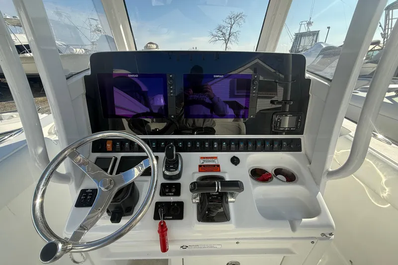 Slide: The Image of 2017 Sea Hunt Gamefish 30 helm with dual Simrad displays and steering wheel. - 5