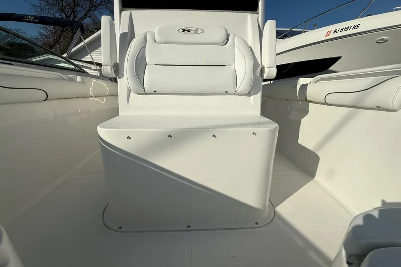 Slide: The Image of 2017 Sea Hunt Gamefish 30 boat interior with white seating and clean deck. - 9