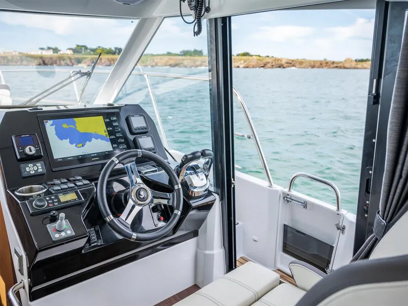 Slide: The Image of Manufacturer Provided Image: 2025 Beneteau Antares 11 helm with navigation system, steering wheel, and sea view. - 14