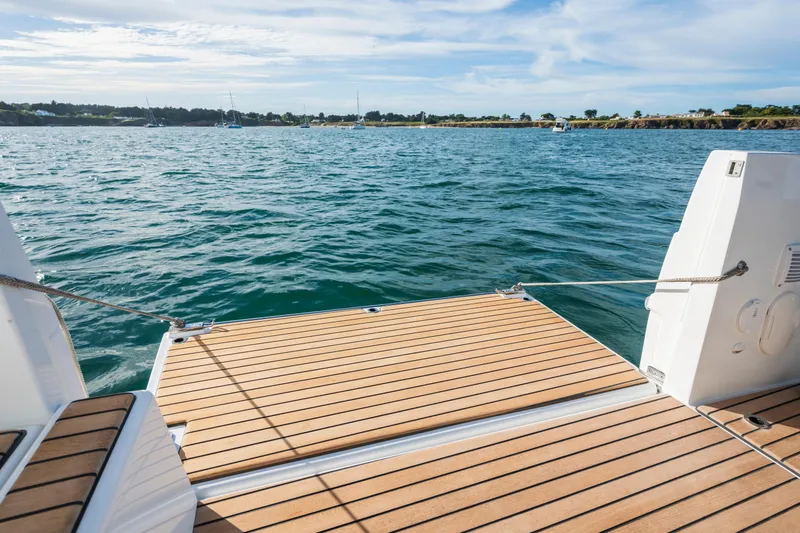 Slide: The Image of 2026 Beneteau Antares 11 Coupe boat deck overlooking serene ocean waters. - 8