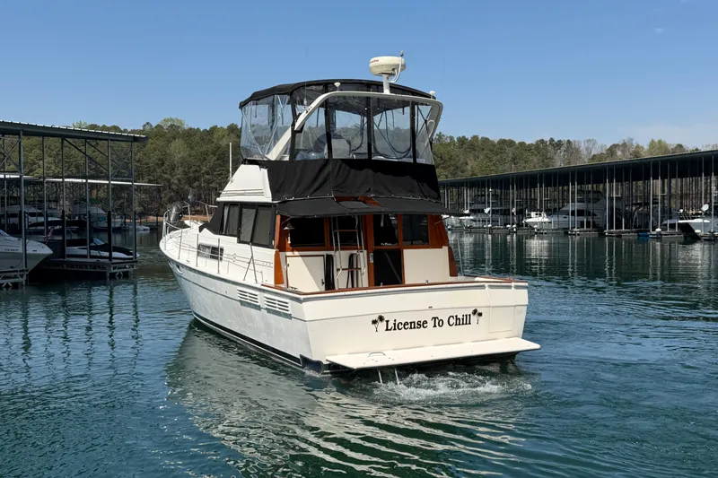 Slide: The Image of 1994 Bayliner 3888 MY Sedan boat named "License To Chill" cruising on a serene lake. - 18