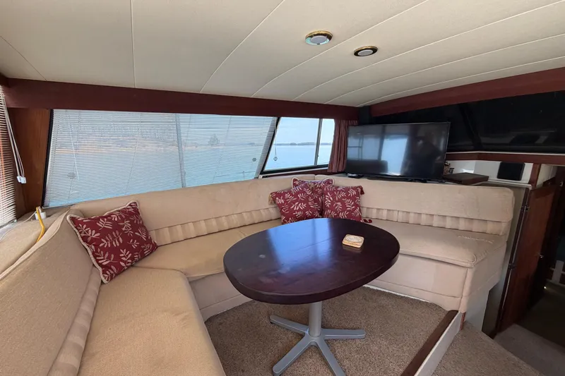 Slide: The Image of Luxurious interior of 1994 Bayliner 3888 MY Sedan with cozy seating and TV. - 27