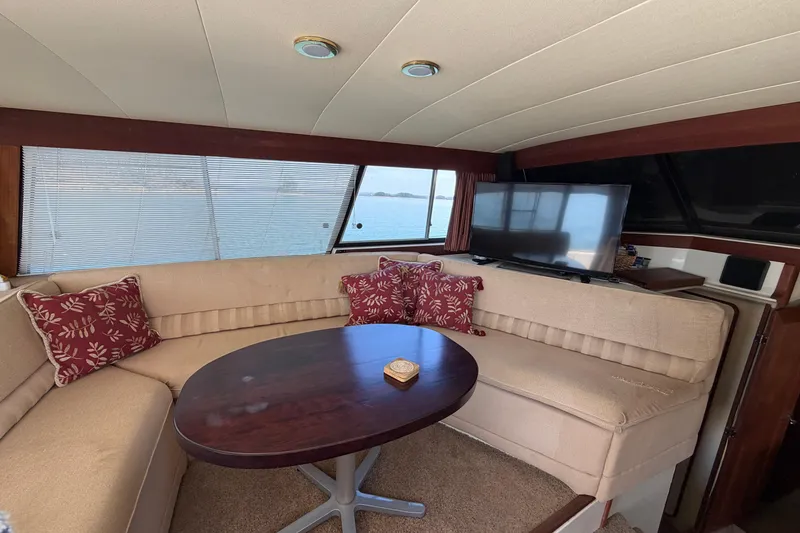 Slide: The Image of Luxurious interior of 1994 Bayliner 3888 MY Sedan with cozy seating and TV. - 28