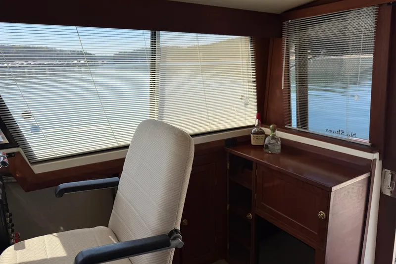 Slide: The Image of Interior of 1994 Bayliner 3888 MY Sedan with chair and wooden cabinetry. - 29