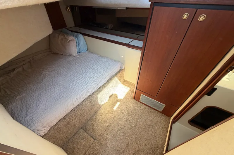 Slide: The Image of Cozy cabin interior of 1994 Bayliner 3888 MY Sedan with bed and wooden cabinetry. - 32