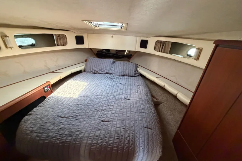 Slide: The Image of Cozy cabin interior of 1994 Bayliner 3888 MY Sedan with bed and porthole windows. - 35