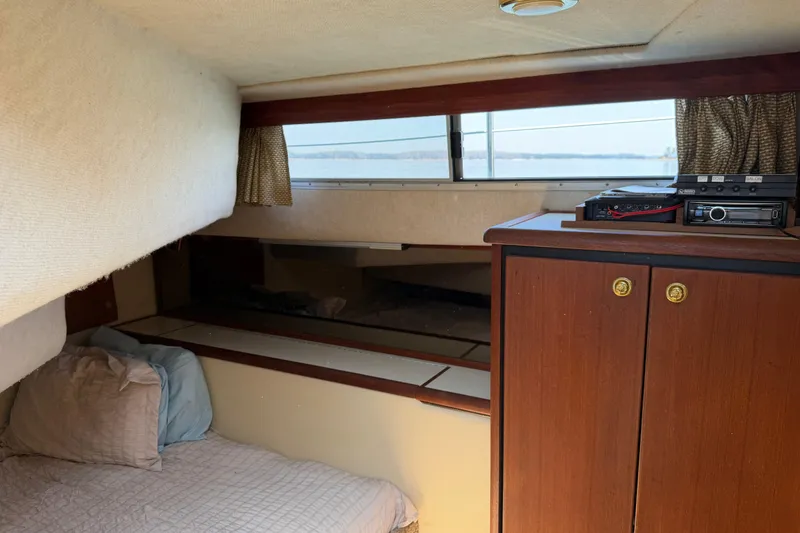 Slide: The Image of Cozy cabin interior of 1994 Bayliner 3888 MY Sedan with bed and wooden cabinetry. - 36