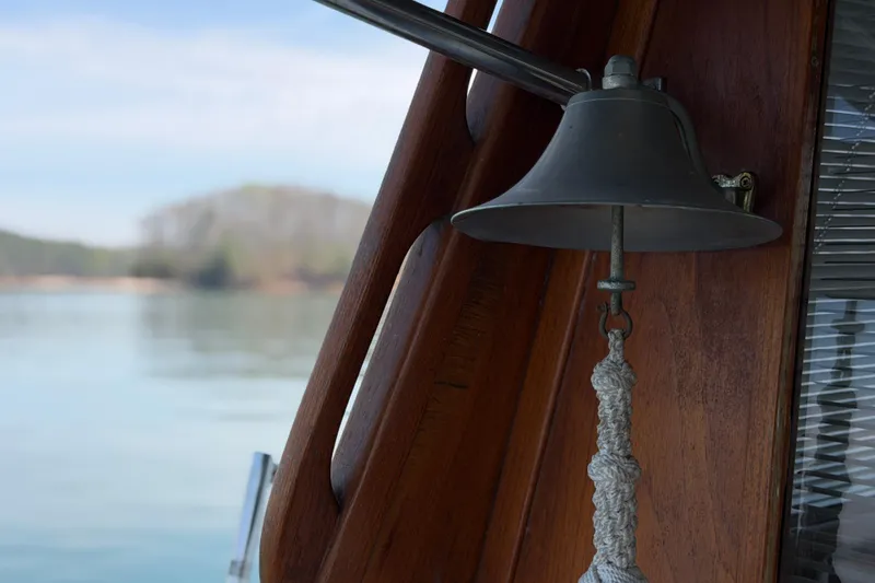 Slide: The Image of Bell on 1994 Bayliner 3888 MY Sedan boat, with serene water background. - 41