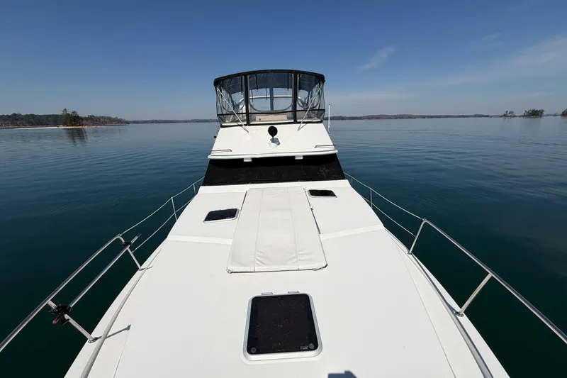 Slide: The Image of 1994 Bayliner 3888 MY Sedan on calm water, showcasing spacious deck and sleek design. - 43