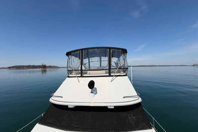 Slide: The Image of 1994 Bayliner 3888 MY Sedan on calm water under clear blue sky. - 44