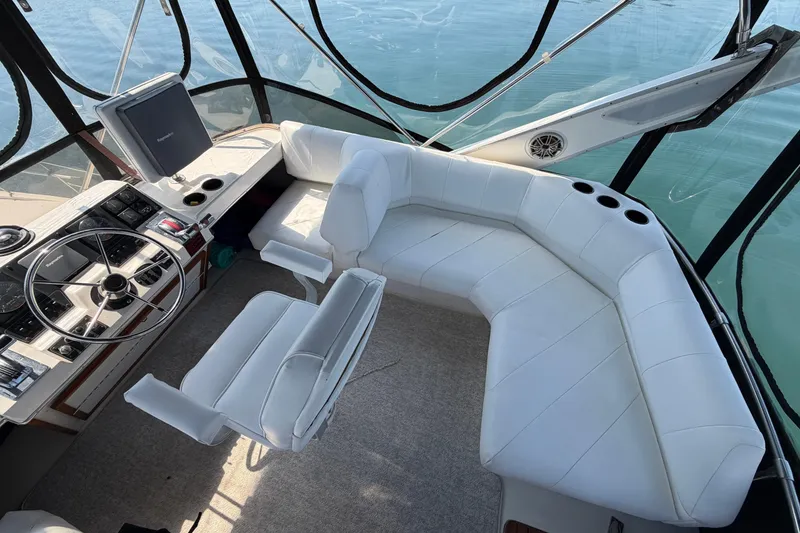 Slide: The Image of 1994 Bayliner 3888 MY Sedan interior with white seating and steering console. - 46